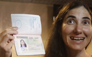 Cuba's best-known dissident, blogger Yoani Sanchez poses with her passport after arriving at Guararapes International airport in Recife